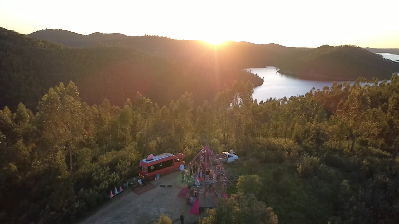 The dome and the bus above the water at sunset.