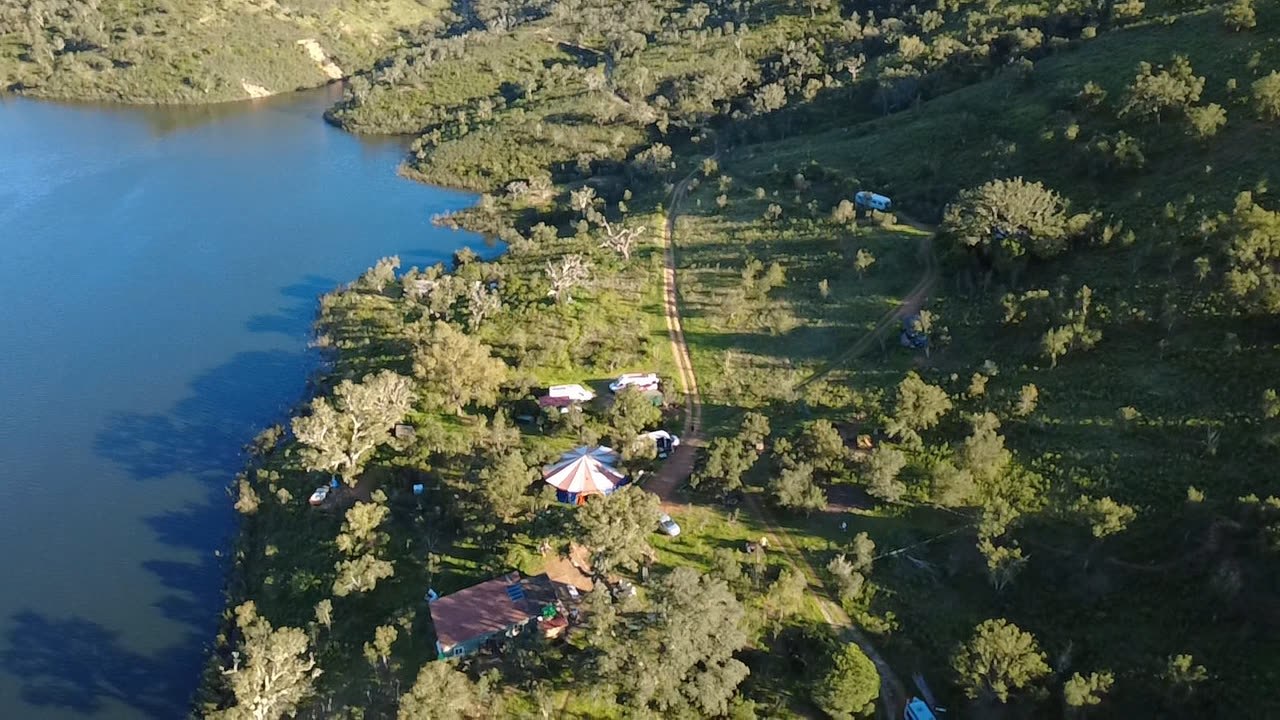 Camp along the shoreline, seen from the air.